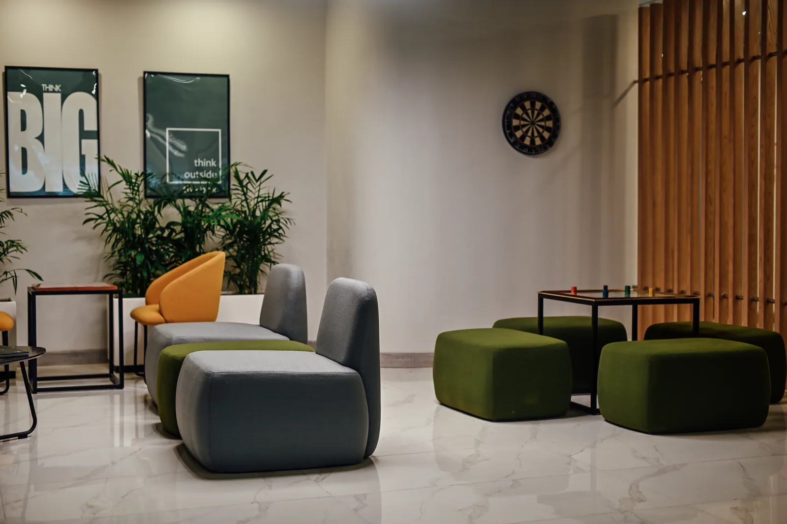 PSO House, 8th-floor rehabilitation, Karachi: Soft seats, a games table and a timber edge. 8th-floor rehabilitation photography.