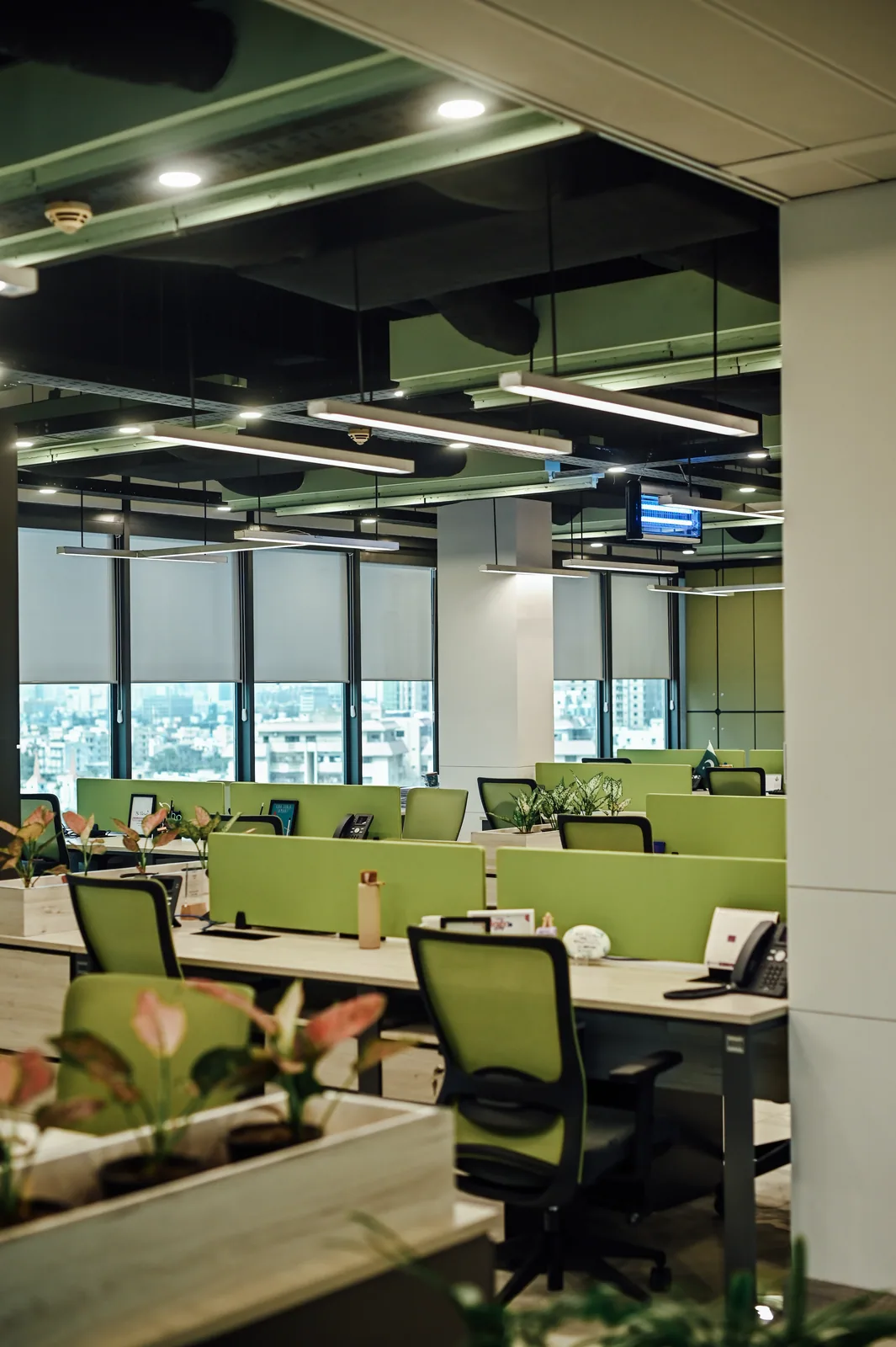 PSO House, 8th-floor rehabilitation, Karachi: Shared desks beneath an open ceiling pattern. 8th-floor rehabilitation photography.