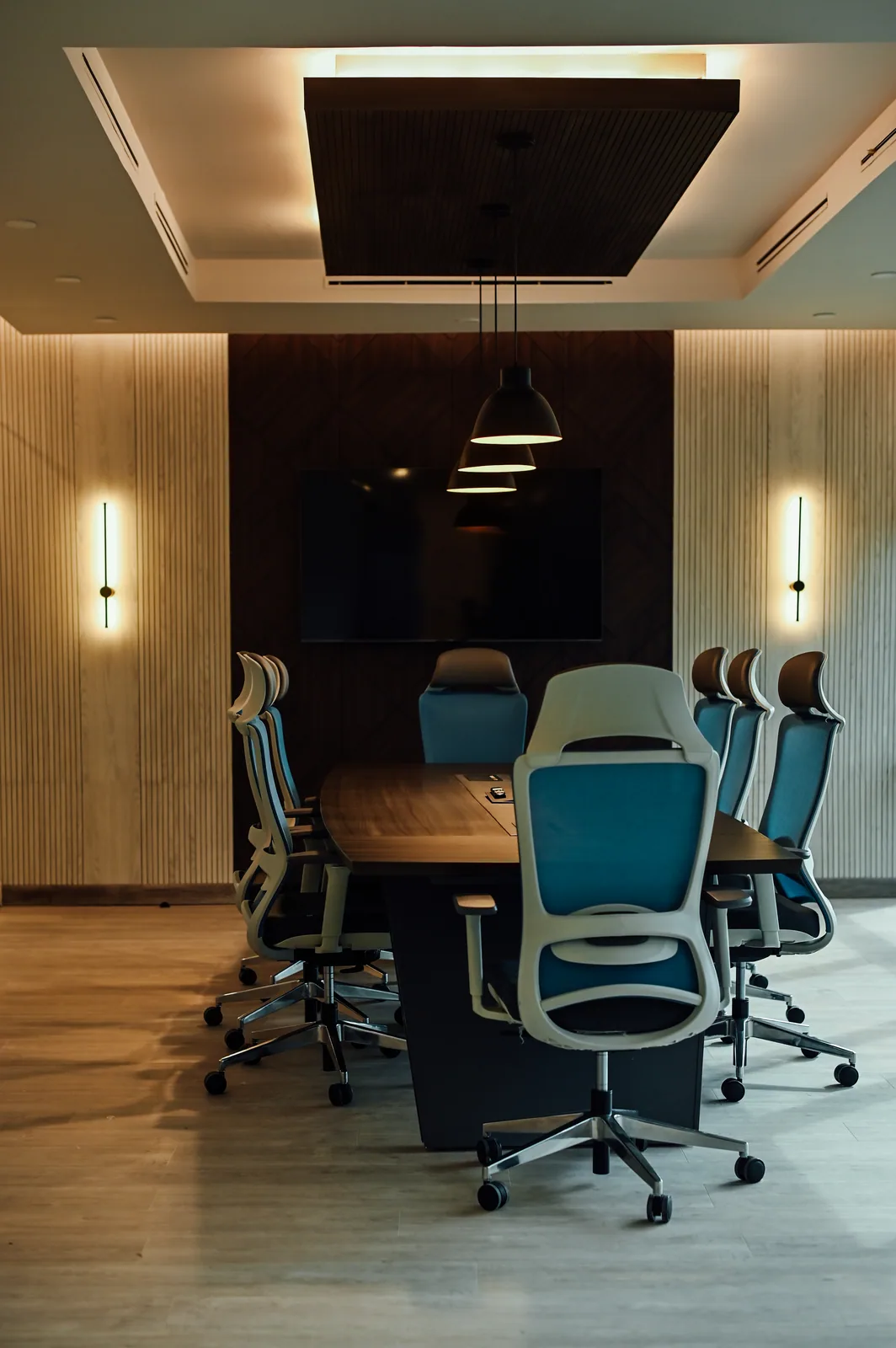 PSO House, 8th-floor rehabilitation, Karachi: A conference room framed by warm wall lighting. 8th-floor rehabilitation photography.