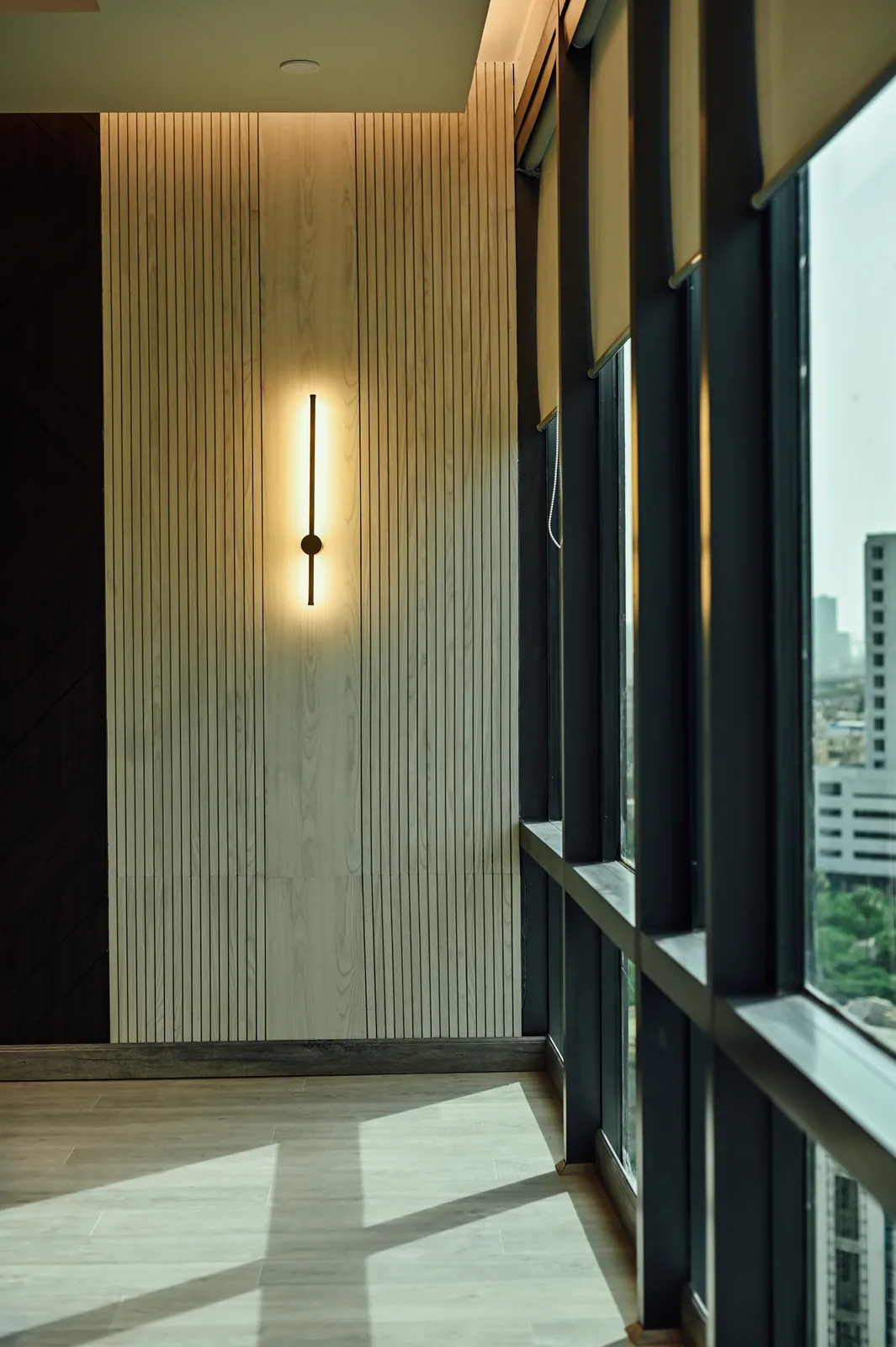 PSO House, 8th-floor rehabilitation, Karachi: A slender wall light on a ribbed surface. 8th-floor rehabilitation photography.