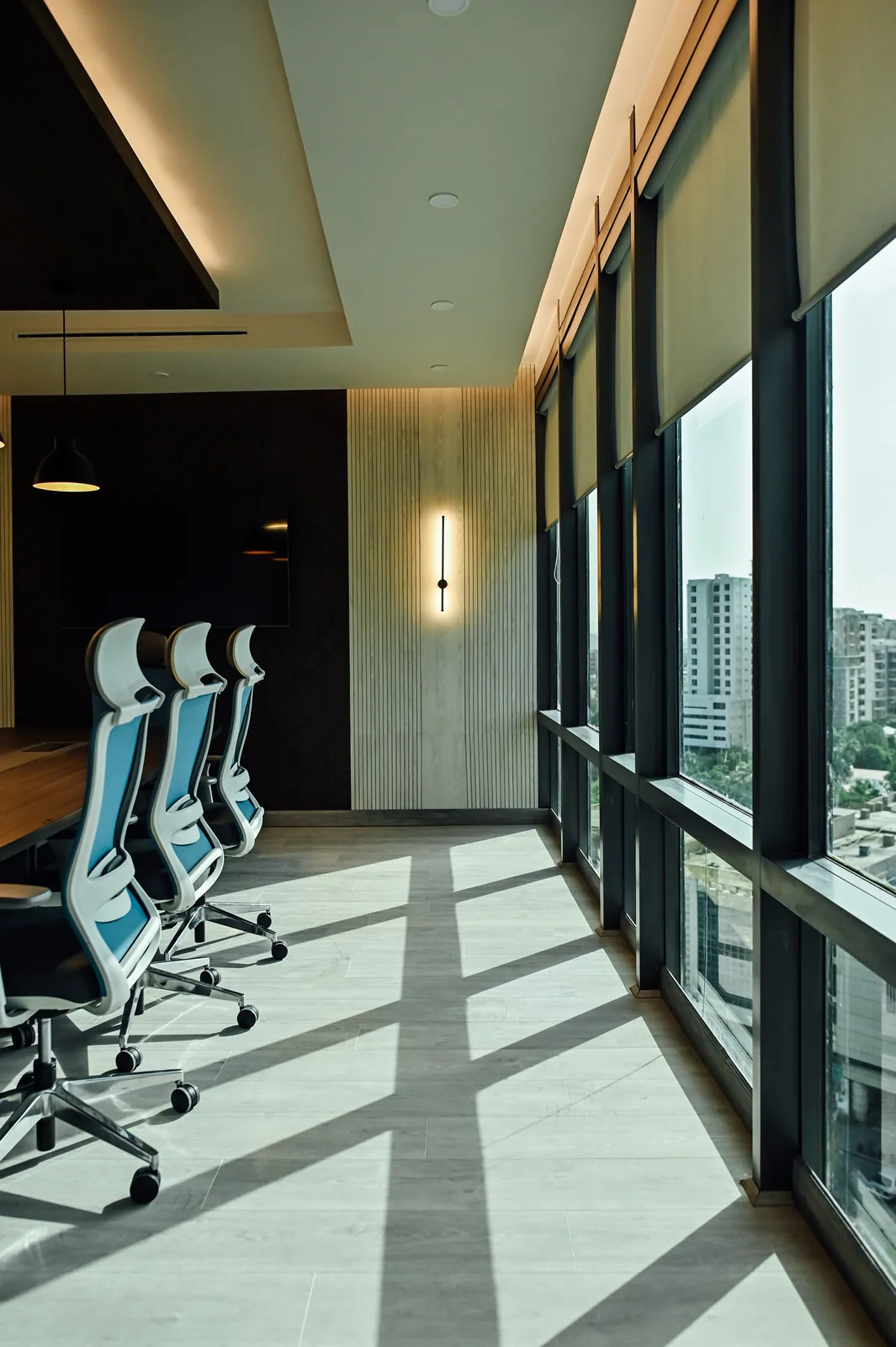 PSO House, 8th-floor rehabilitation, Karachi: Strong daylight shadows beside the conference chairs. 8th-floor rehabilitation photography.