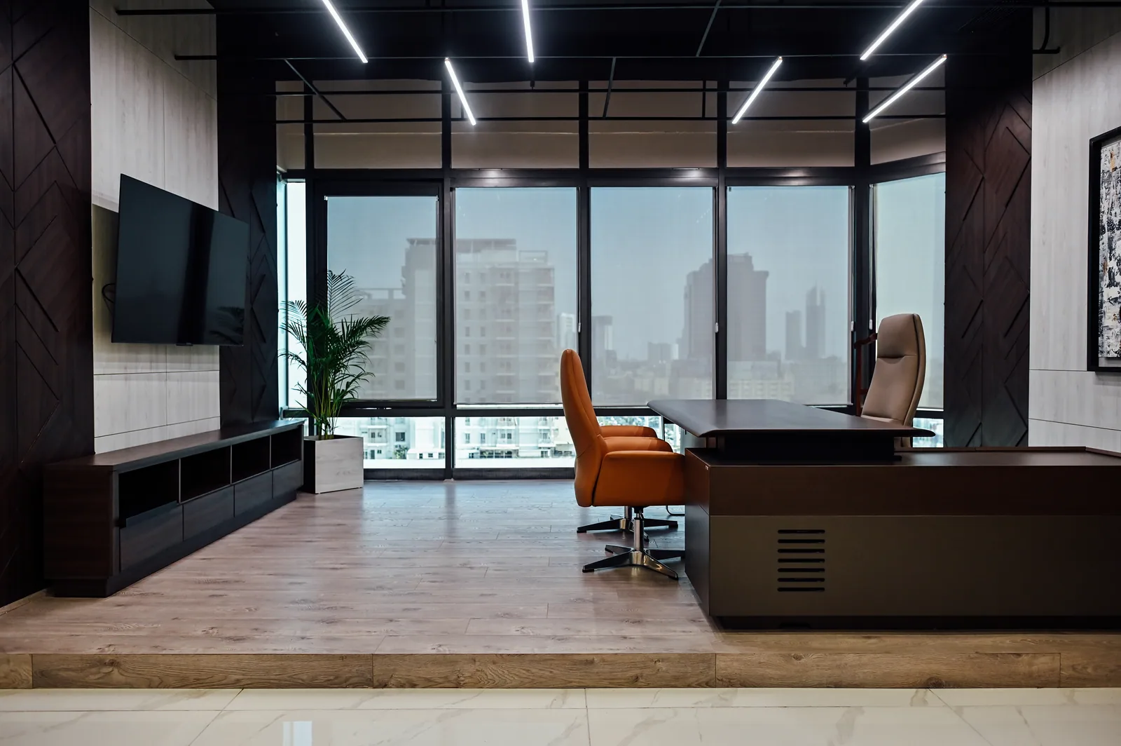 PSO House, 8th-floor rehabilitation, Karachi: An enclosed office beneath a grid of linear lights. 8th-floor rehabilitation photography.