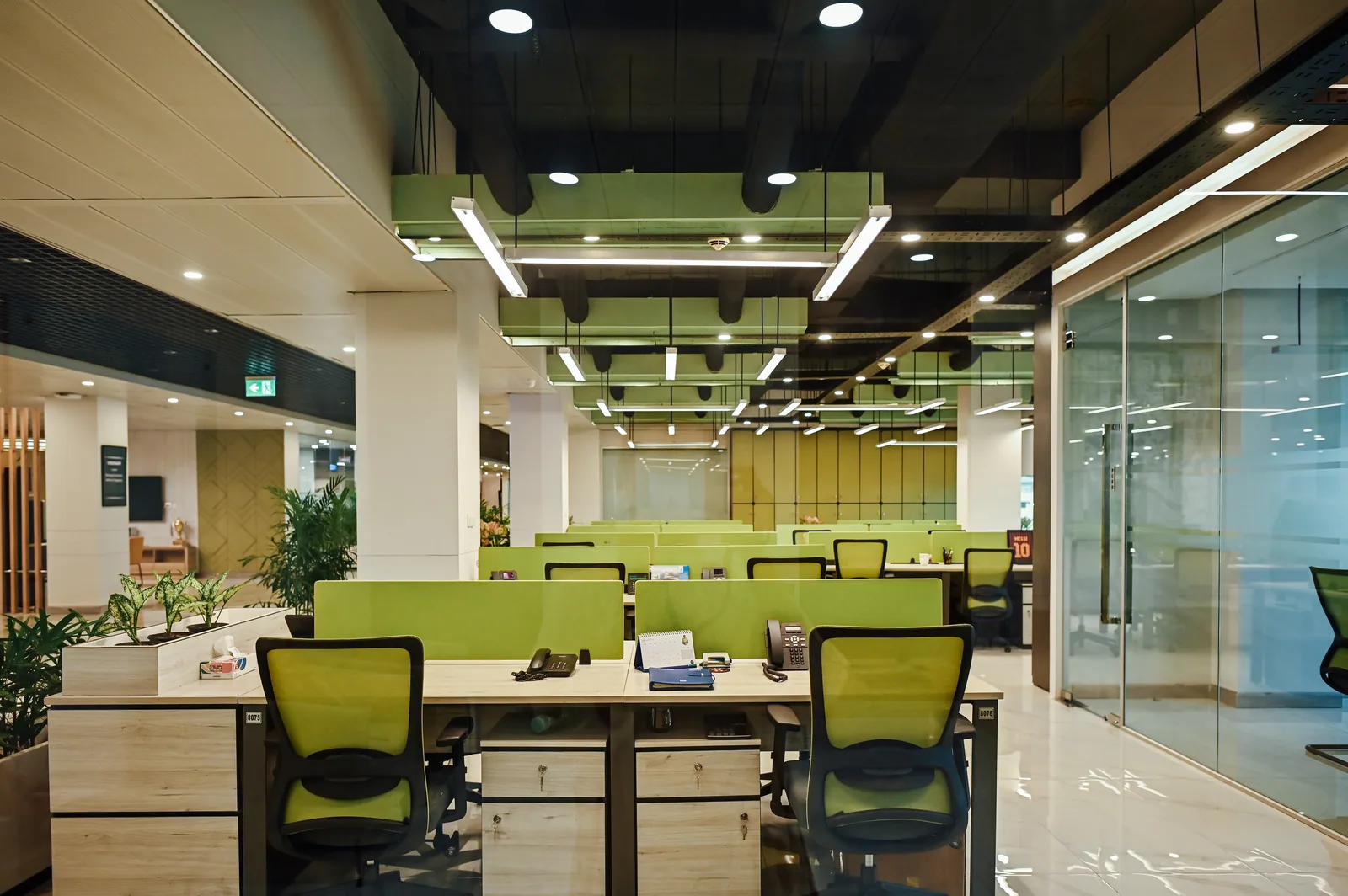 PSO House, 8th-floor rehabilitation, Karachi: Green partitions organise rows of workstations. 8th-floor rehabilitation photography.