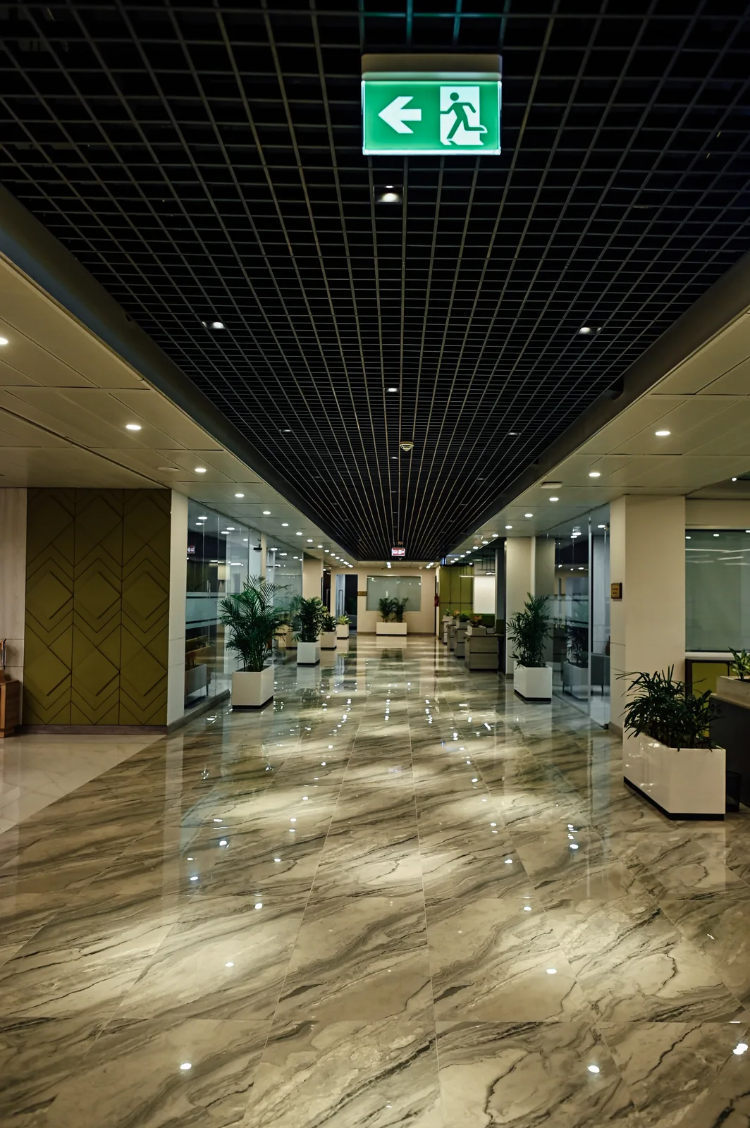 PSO House, 8th-floor rehabilitation, Karachi: A central corridor beneath a dark ceiling grid. 8th-floor rehabilitation photography.