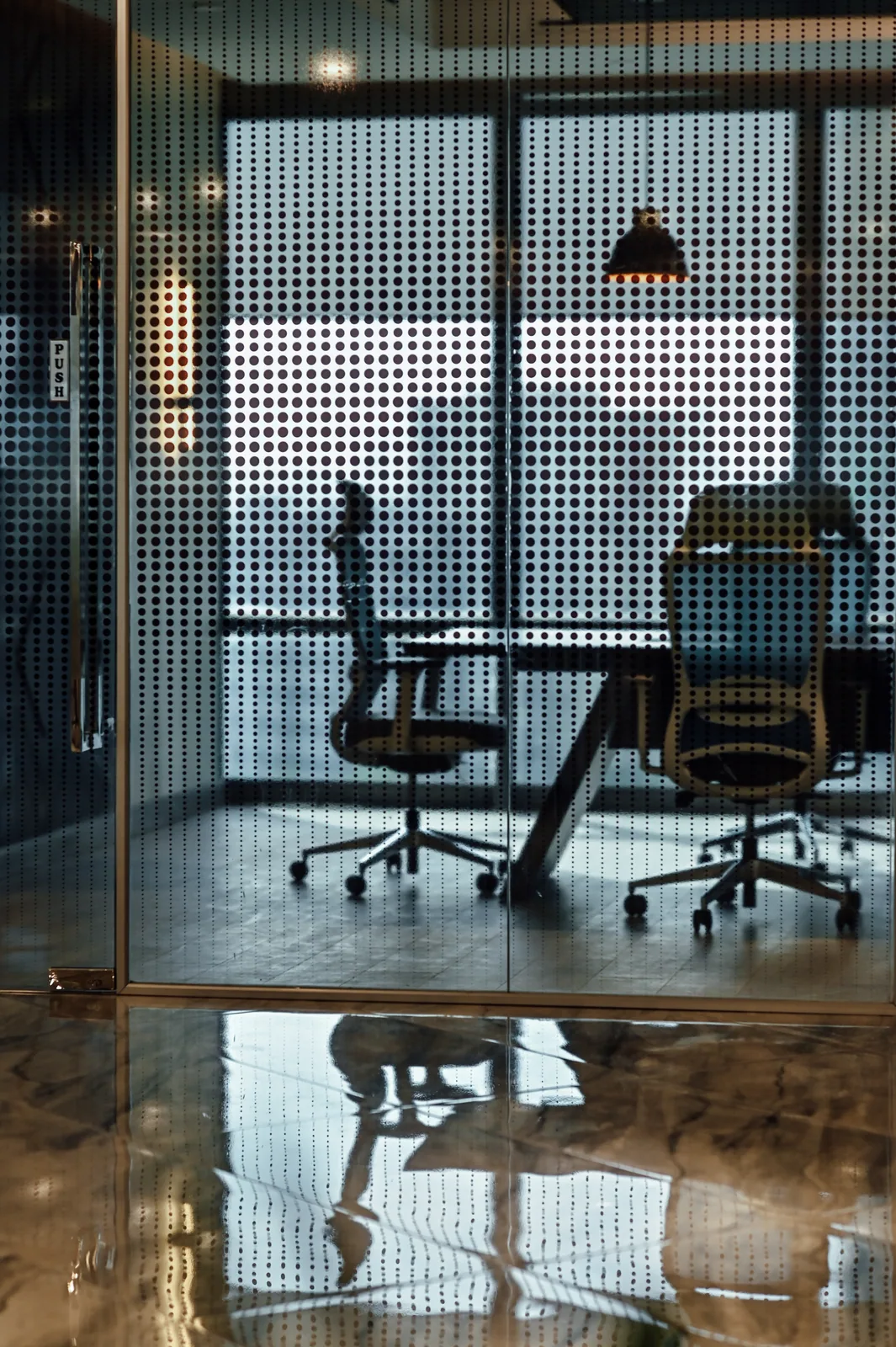 PSO House, 8th-floor rehabilitation, Karachi: Meeting chairs behind a patterned glazed screen. 8th-floor rehabilitation photography.