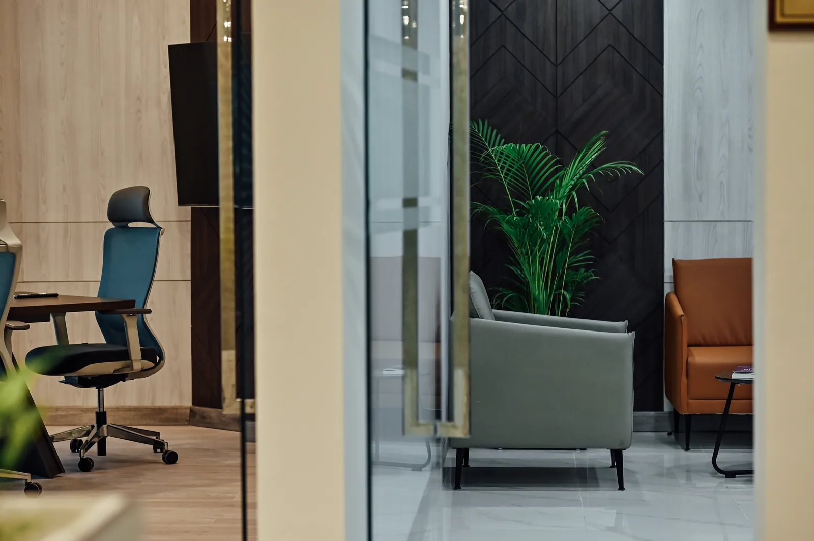 PSO House, 8th-floor rehabilitation, Karachi: An office and lounge meet at a glazed boundary. 8th-floor rehabilitation photography.