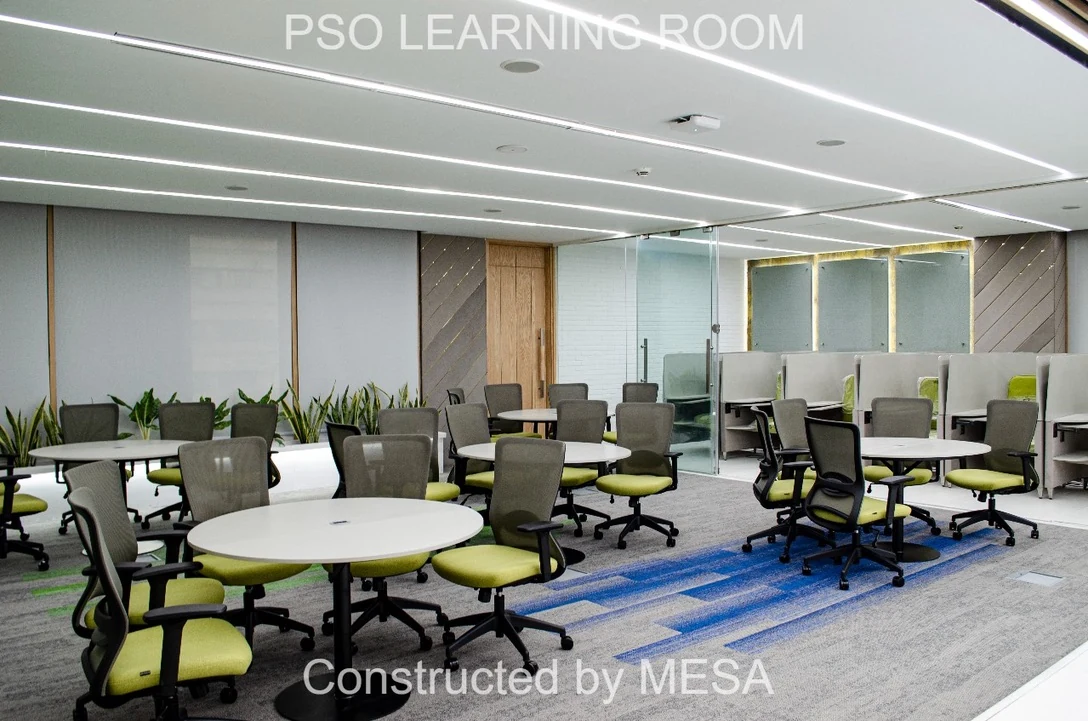Round tables and green chairs in the furnished PSO Learning Room