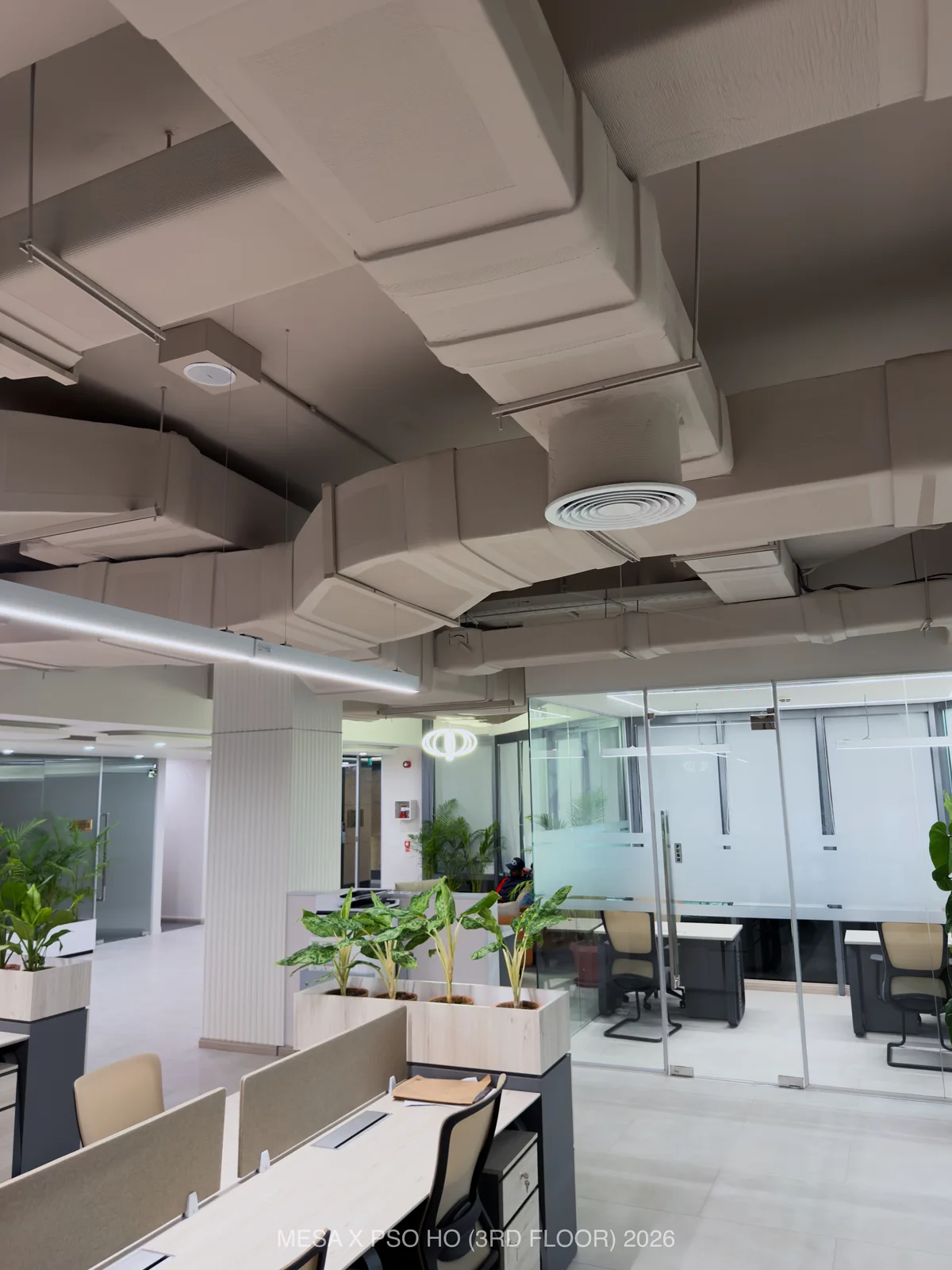 PSO House / Third floor / Exposed ducts, a circular diffuser and suspended linear lighting above the floor.