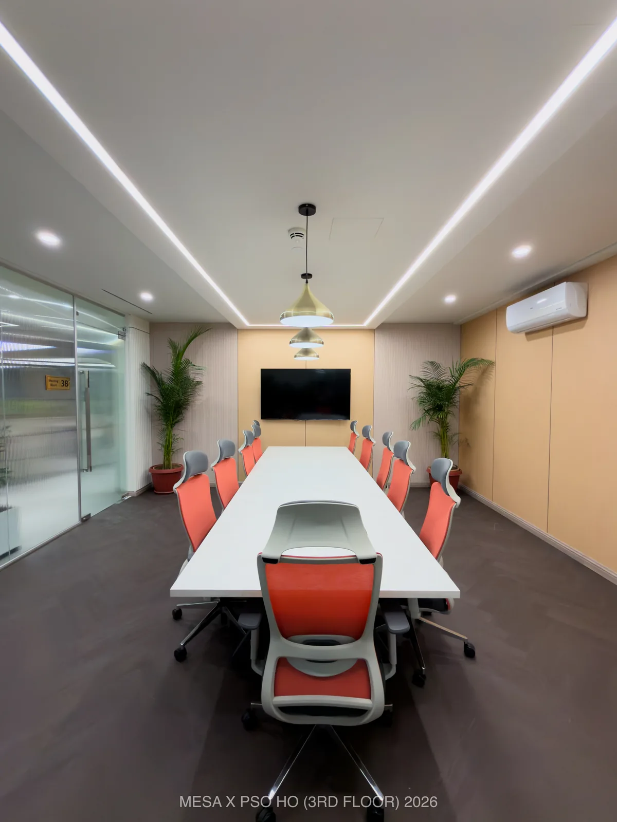 PSO House / Third floor / Linear ceiling light frames the conference table and its presentation wall.