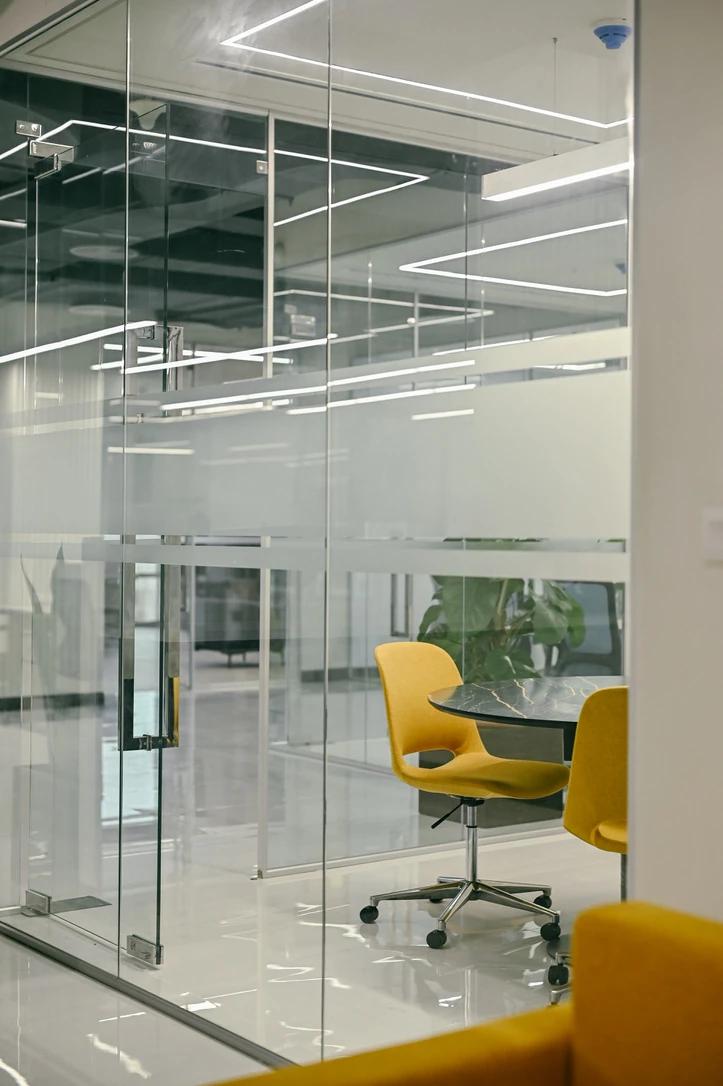 PSO 6th & 7th: Yellow chairs around a table behind glass. 6th–7th-floor interior photography.