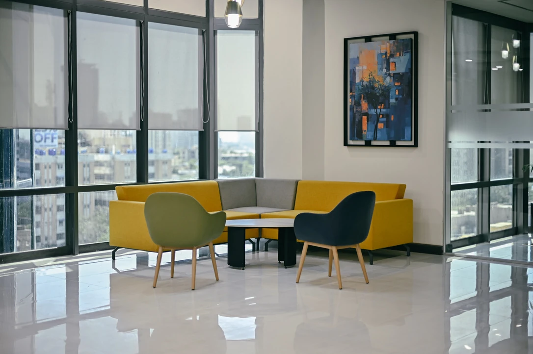 PSO 6th & 7th: Colourful lounge seating against the city windows. 6th–7th-floor interior photography.