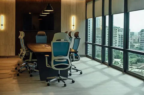 PSO House, 8th-floor rehabilitation, Karachi: A long conference table along the window wall. 8th-floor rehabilitation photography.