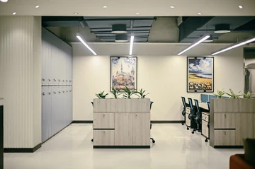 PSO 6th & 7th: Planted storage units mark the ends of work bays. 6th–7th-floor interior photography.