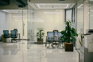 PSO 6th & 7th: Glazed work rooms beside planting and a bright corridor. 6th–7th-floor interior photography.