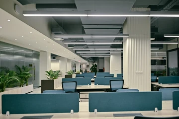 PSO 6th & 7th: Blue screens repeat beneath a field of linear lights. 6th–7th-floor interior photography.