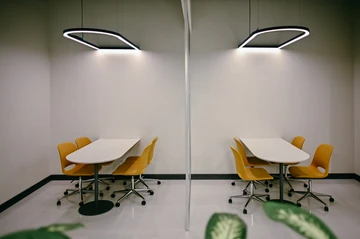 PSO 6th & 7th: Two yellow-chair meeting settings behind a glass boundary. 6th–7th-floor interior photography.