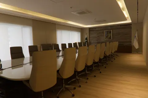 Soha office collection: Warm timber flooring and beige seating define the boardroom. Project photography.